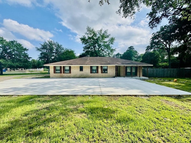 back of house with a patio and a lawn