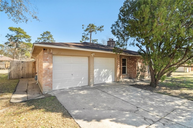 ranch-style house with a garage and an outbuilding