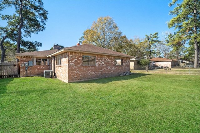 view of home's exterior with a yard and central air condition unit