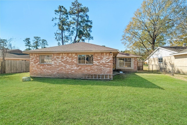 rear view of property featuring a yard