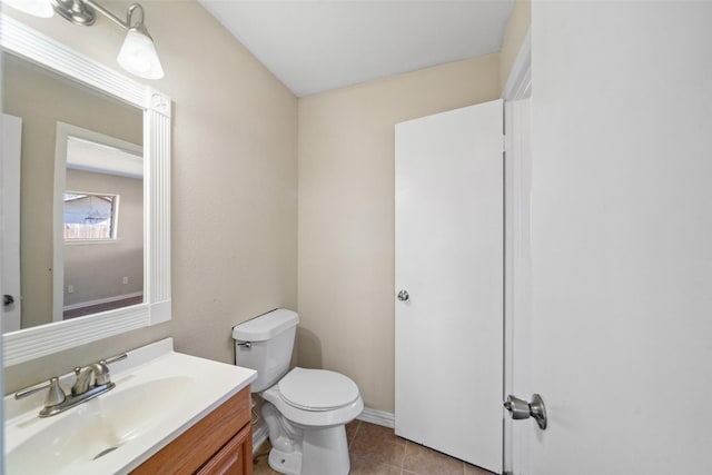 bathroom with vanity, tile patterned floors, and toilet