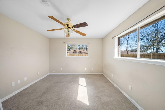 empty room with ceiling fan and carpet flooring