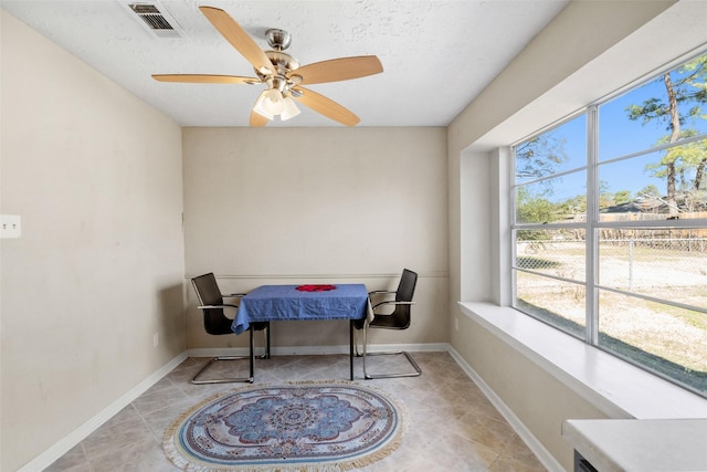 tiled dining area with a textured ceiling