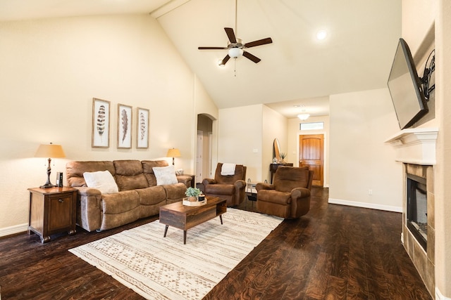 living room with dark wood-type flooring, high vaulted ceiling, and ceiling fan