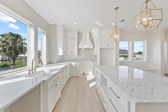 23015 Lunes, Galveston, TX 77554 - kitchen with premium range hood, a sink, recessed lighting, a chandelier, and healthy amount of natural light