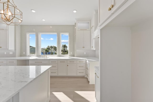 23015 Lunes, Galveston, TX 77554 - kitchen with a sink, light stone counters, backsplash, white cabinetry, and recessed lighting
