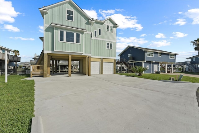 23015 Lunes, Galveston, TX 77554 - coastal home with stairway, board and batten siding, a carport, and driveway
