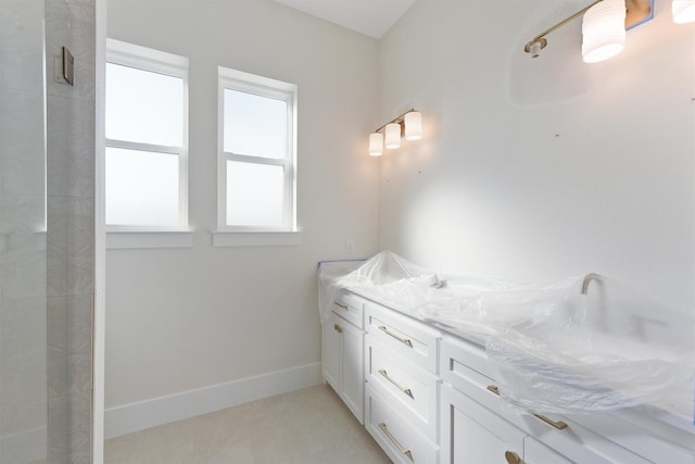 23015 Lunes, Galveston, TX 77554 - full bath featuring a tile shower, double vanity, and baseboards