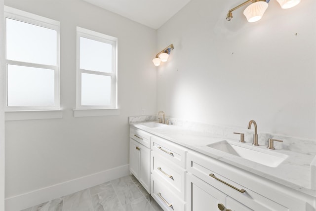 23015 Lunes, Galveston, TX 77554 - bathroom featuring double vanity, marble look tiles, and baseboards