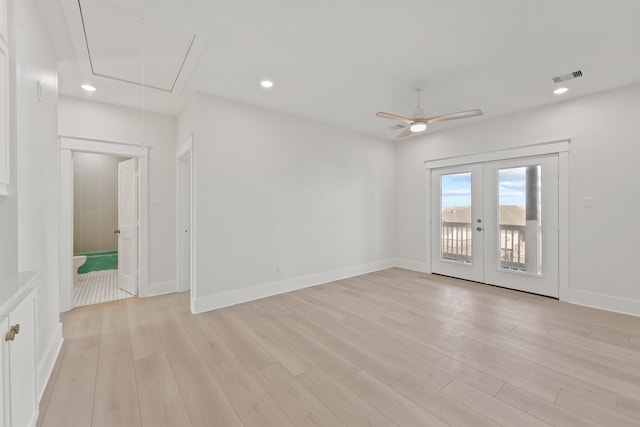 23015 Lunes, Galveston, TX 77554 - unfurnished room with attic access, french doors, light wood-style floors, a ceiling fan, and baseboards