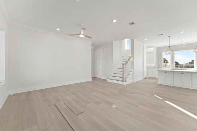 23015 Lunes, Galveston, TX 77554 - unfurnished living room with stairway, light wood-style floors, crown molding, baseboards, and recessed lighting