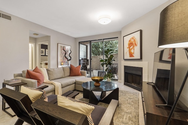 tiled living room with a tiled fireplace