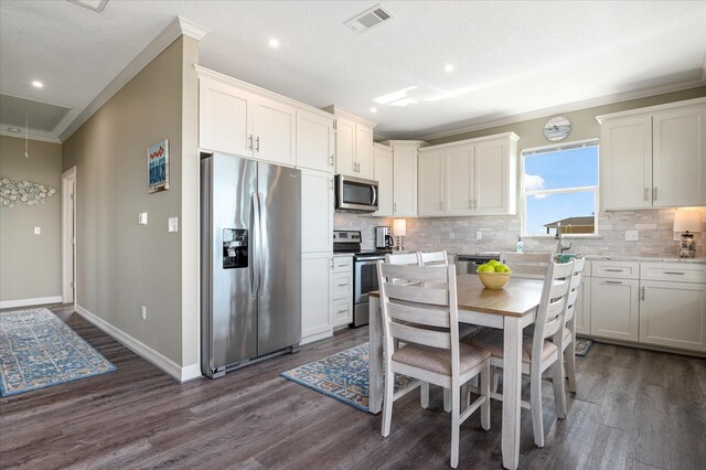 kitchen featuring white cabinetry, light stone counters, and stainless steel appliances