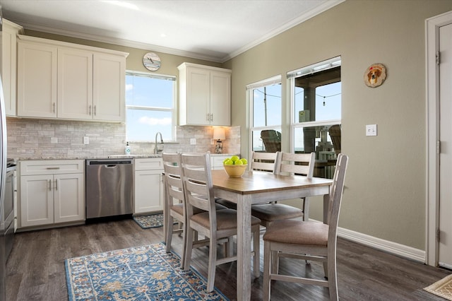 kitchen with dishwasher, white cabinets, decorative backsplash, ornamental molding, and light stone countertops