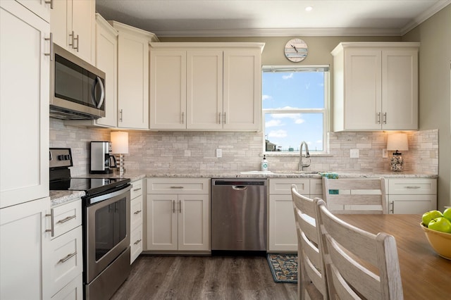 kitchen featuring dark hardwood / wood-style flooring, crown molding, light stone countertops, and appliances with stainless steel finishes