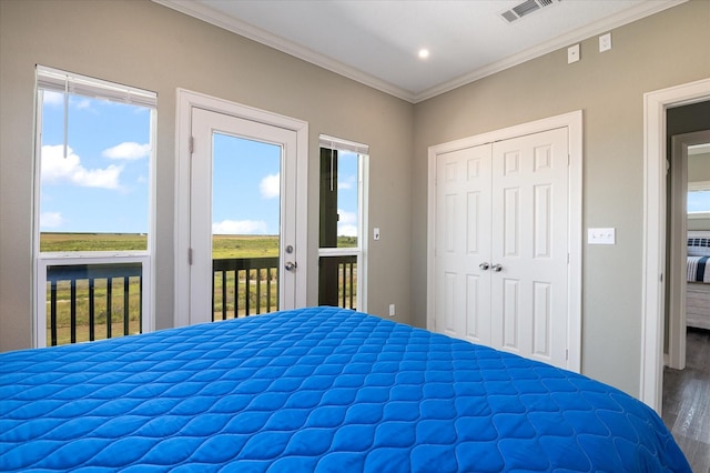 unfurnished bedroom featuring crown molding, wood-type flooring, access to outside, and a closet