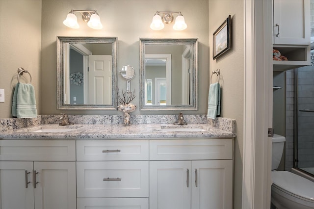 full bathroom with vanity, combined bath / shower with glass door, and toilet