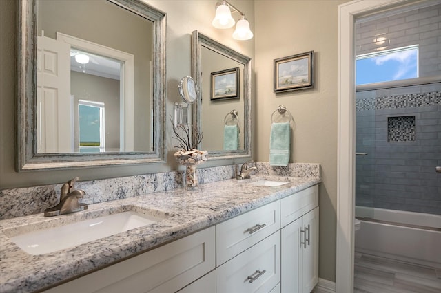 full bathroom with vanity, toilet, and tiled shower / bath combo