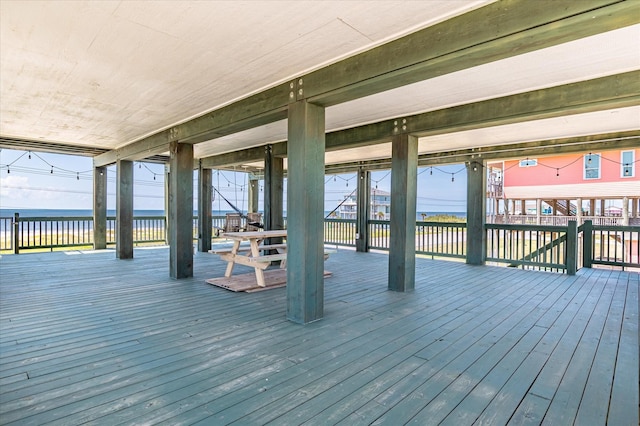 wooden terrace featuring a water view