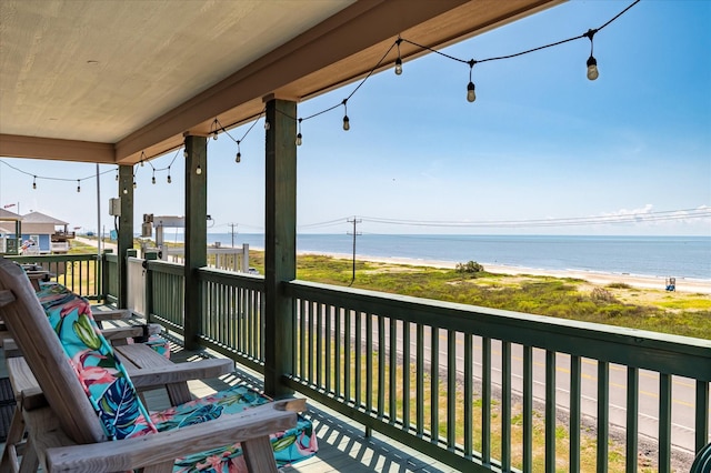 balcony with a water view and a beach view