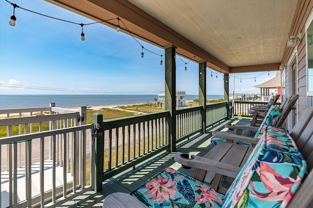 wooden terrace featuring a water view