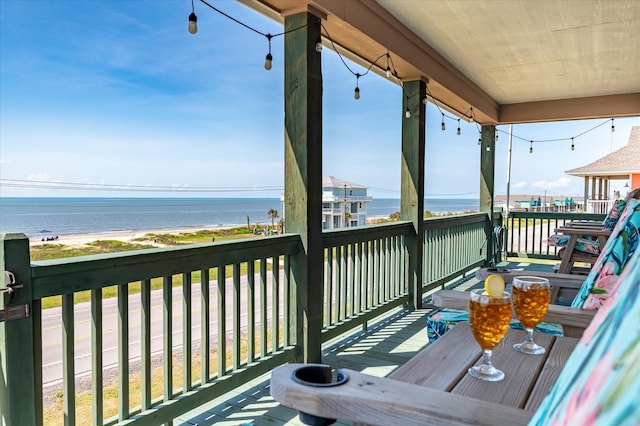 wooden terrace featuring a water view