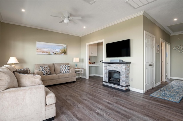 living room featuring ornamental molding, dark wood-type flooring, a fireplace, and ceiling fan