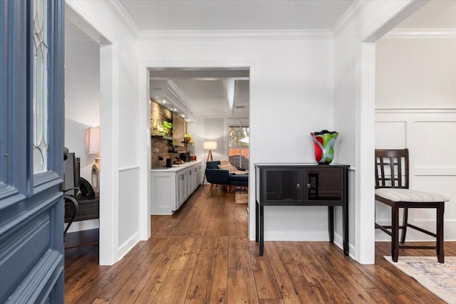 hall with crown molding and dark wood-type flooring