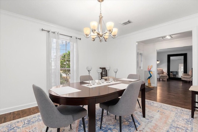 dining space with an inviting chandelier, ornamental molding, and dark hardwood / wood-style floors