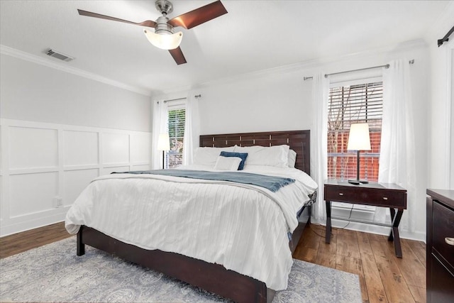 bedroom featuring crown molding, ceiling fan, and light hardwood / wood-style flooring