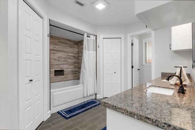 bathroom featuring vanity and shower / bath combo