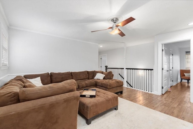 living room featuring ornamental molding, ceiling fan, and light hardwood / wood-style floors