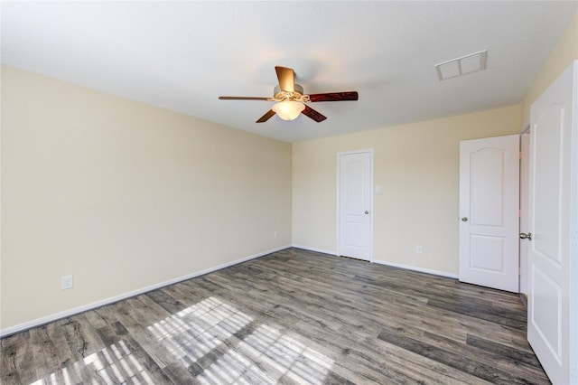 spare room featuring dark hardwood / wood-style floors and ceiling fan