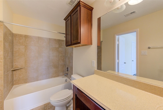 full bathroom featuring vanity, toilet, tiled shower / bath combo, and tile patterned flooring