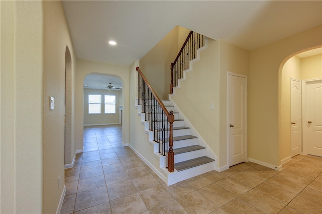 stairway with tile patterned floors