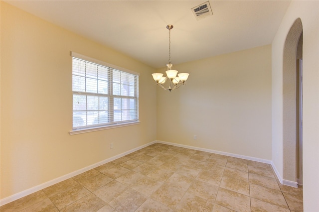 empty room featuring an inviting chandelier