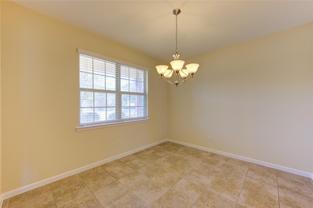 unfurnished room featuring a notable chandelier