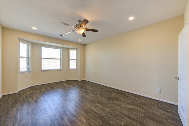 empty room with ceiling fan and dark hardwood / wood-style flooring