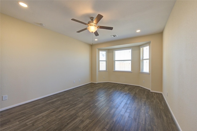 empty room featuring dark wood-type flooring and ceiling fan