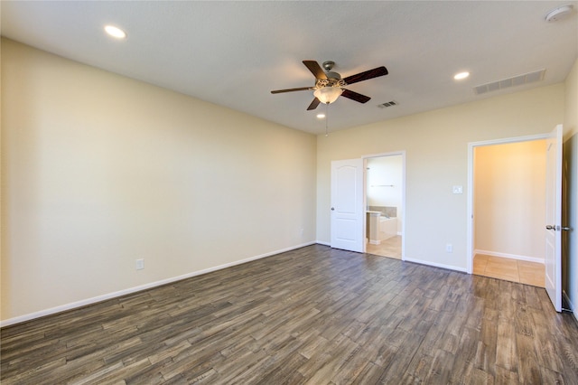 unfurnished bedroom with ceiling fan, connected bathroom, and dark hardwood / wood-style flooring