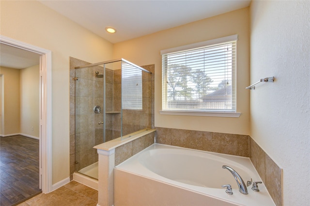 bathroom featuring tile patterned floors and independent shower and bath