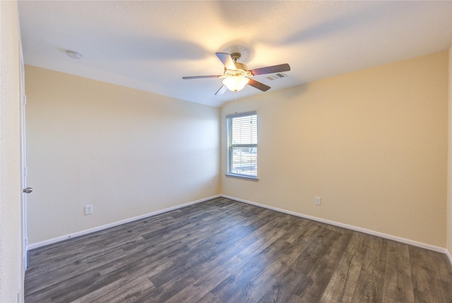 empty room with dark wood-type flooring and ceiling fan