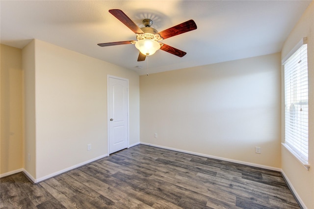 empty room featuring dark wood-type flooring and ceiling fan