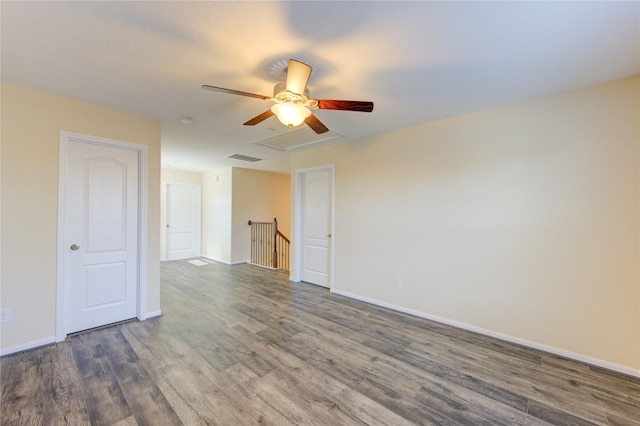 spare room with ceiling fan and dark hardwood / wood-style flooring