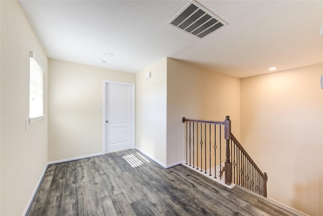 hallway with dark hardwood / wood-style floors