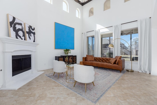 living room with a towering ceiling and light tile patterned floors