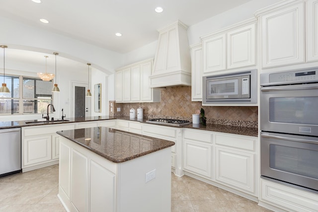 kitchen with white cabinetry, sink, stainless steel appliances, and custom range hood