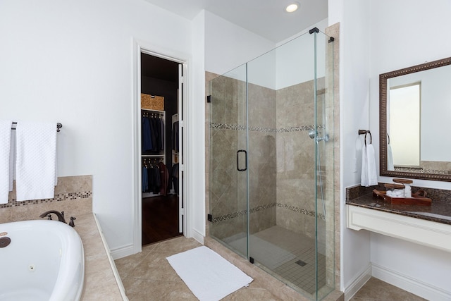 bathroom featuring tile patterned floors, separate shower and tub, and vanity