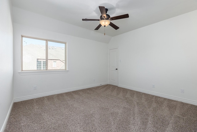 carpeted spare room with vaulted ceiling and ceiling fan