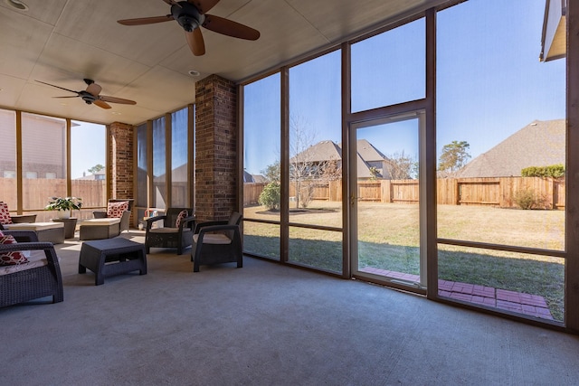 unfurnished sunroom featuring ceiling fan